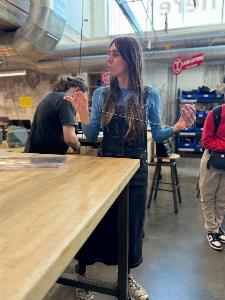 Lucy demonstrates the use of plexiglass as a material for laser cutting